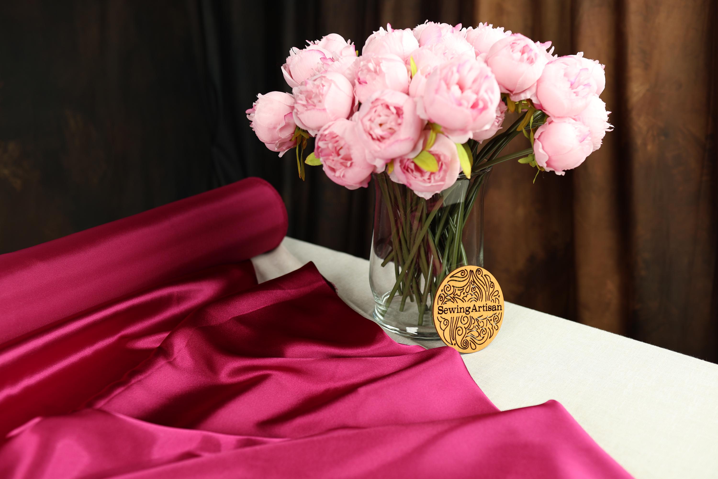 a vase filled with pink flowers on top of a table