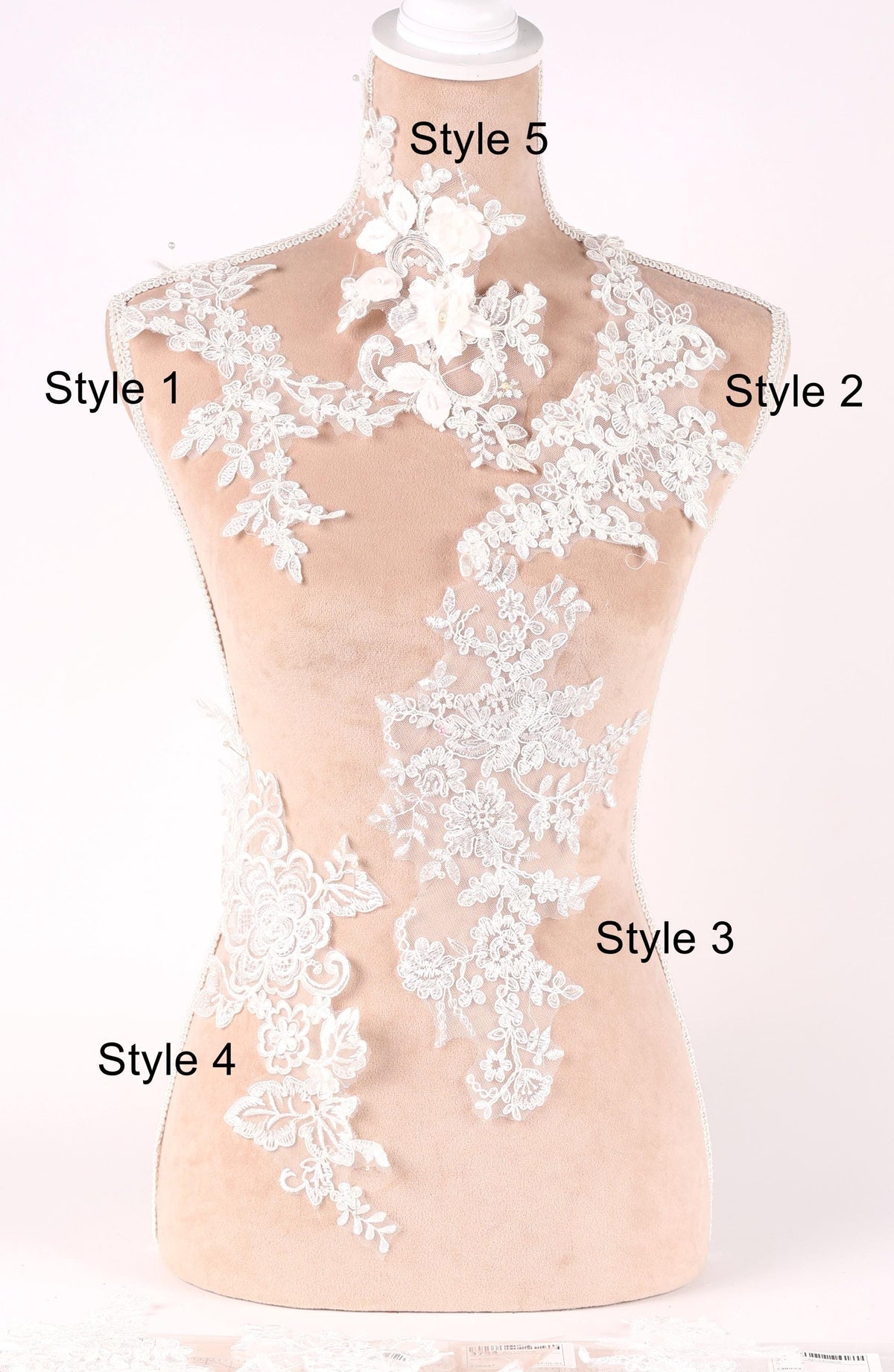 A mannequin with various styles of lace and floral embroidery displayed on its bust and shoulders.