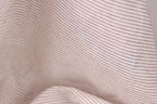 A close-up view of a fabric with horizontal brown and white stripes, creating a textured and visually interesting pattern.