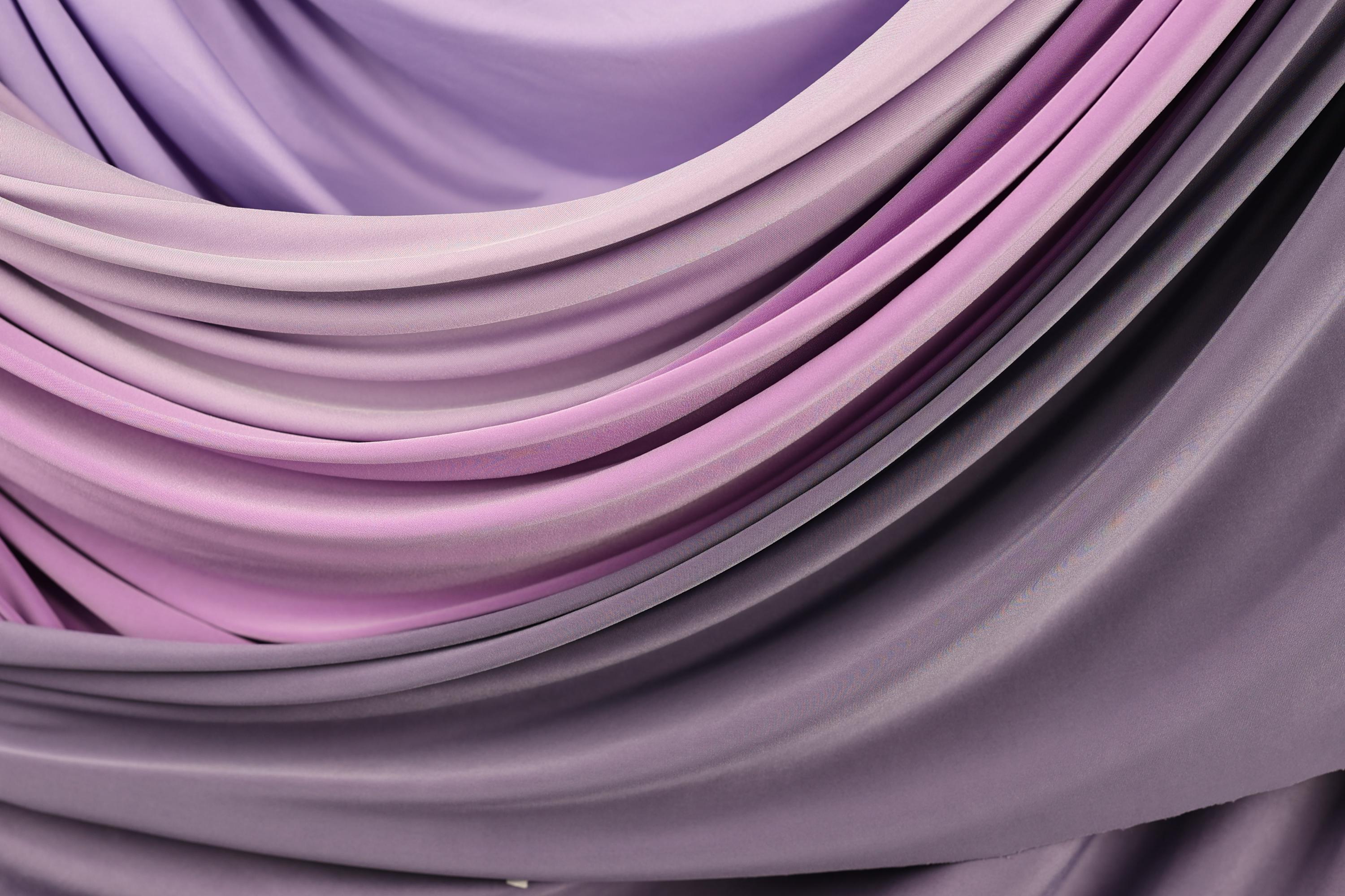 a close-up view of a fabric with a gradient of purple and pink colors, creating a visually appealing and textured appearance.