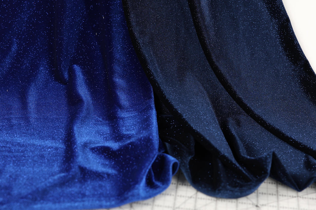 a close-up view of a blue fabric with a shiny, glittery texture.