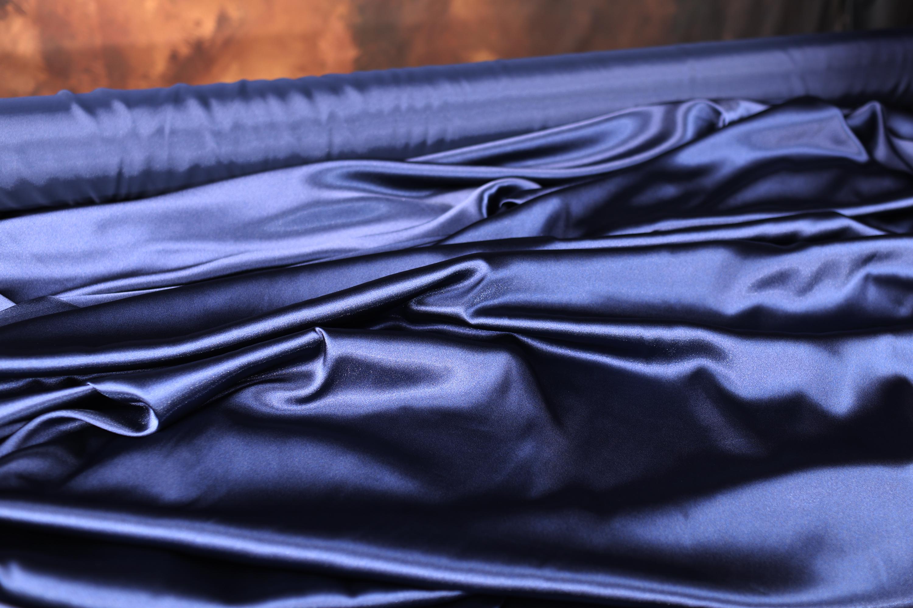 a close up of a bed with blue sheets