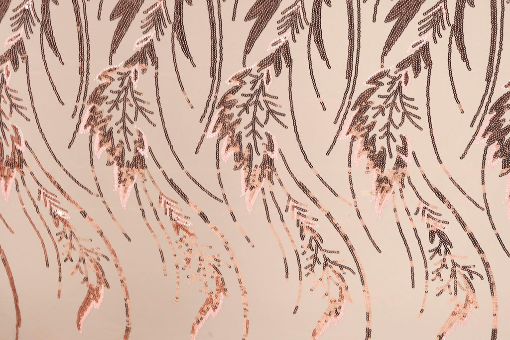 a close-up view of a patterned fabric with a repeating design of brown leaves and stems. The leaves appear to be made of sequins or beads, creating a textured and visually interesting surface.