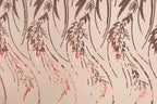a close-up view of a patterned fabric with a repeating design of brown leaves and stems. The leaves appear to be made of sequins or beads, creating a textured and visually interesting surface.