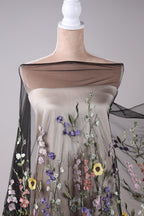 A mannequin wearing a dress with a floral pattern on the bodice and sleeves.