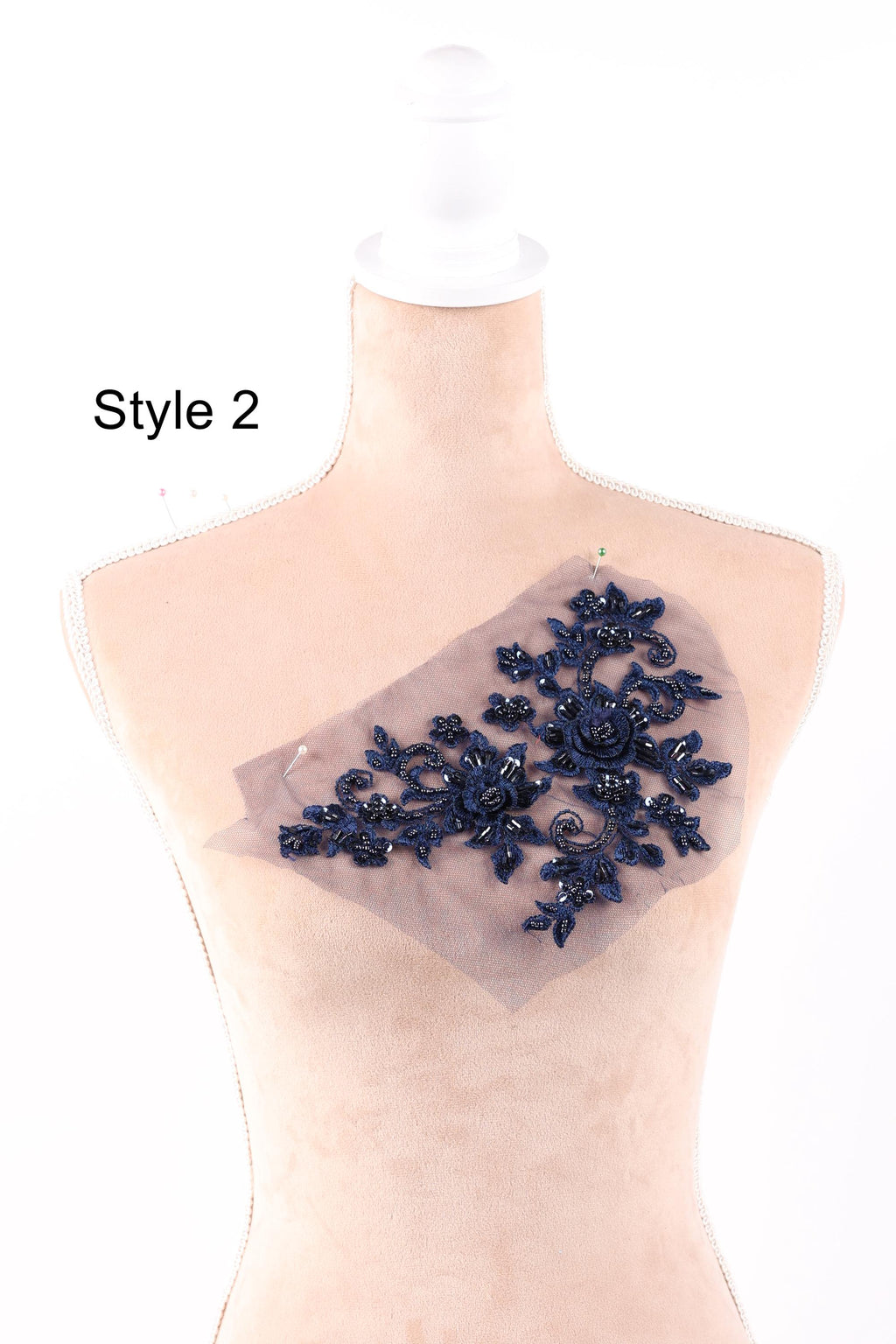 A mannequin with a decorative blue floral embroidery on its chest.