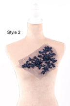 A mannequin with a decorative blue floral embroidery on its chest.