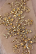 a close up of a gold embroidered fabric