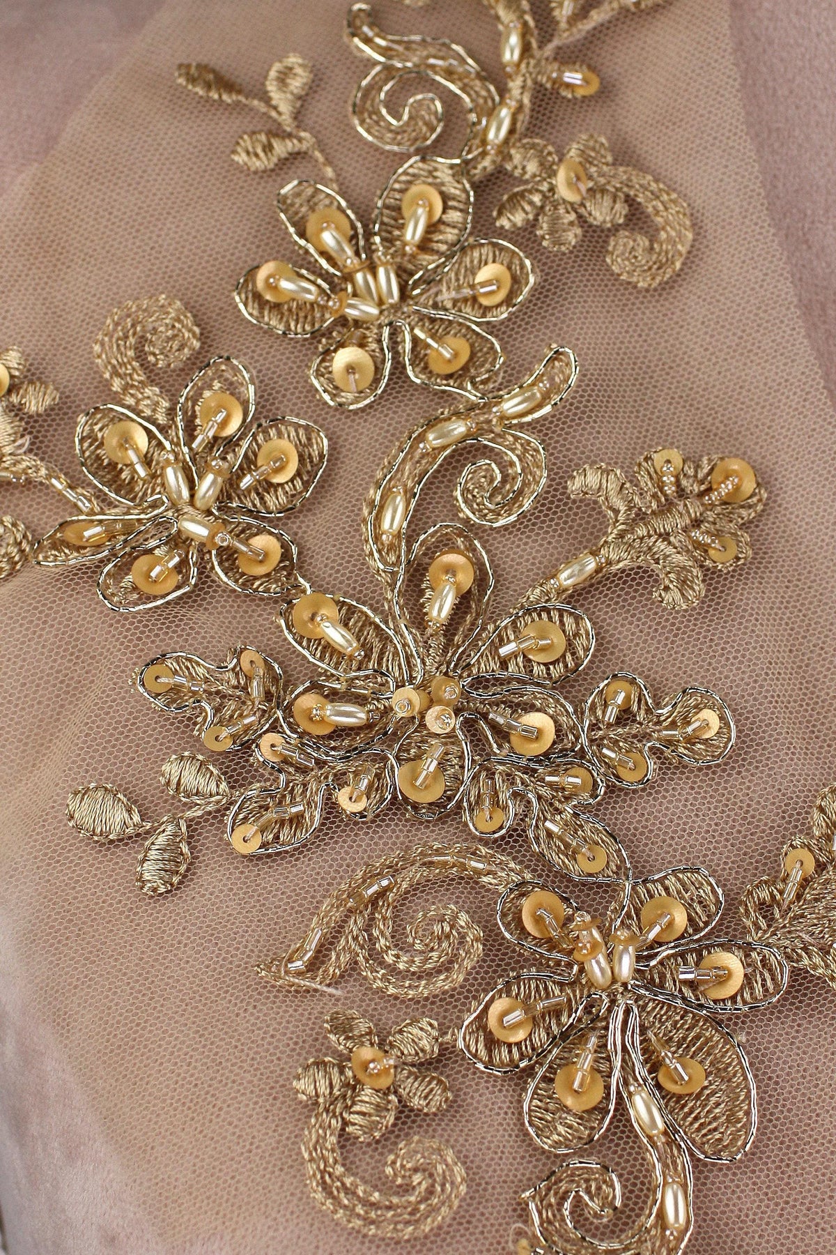 a close up of a gold embroidered fabric