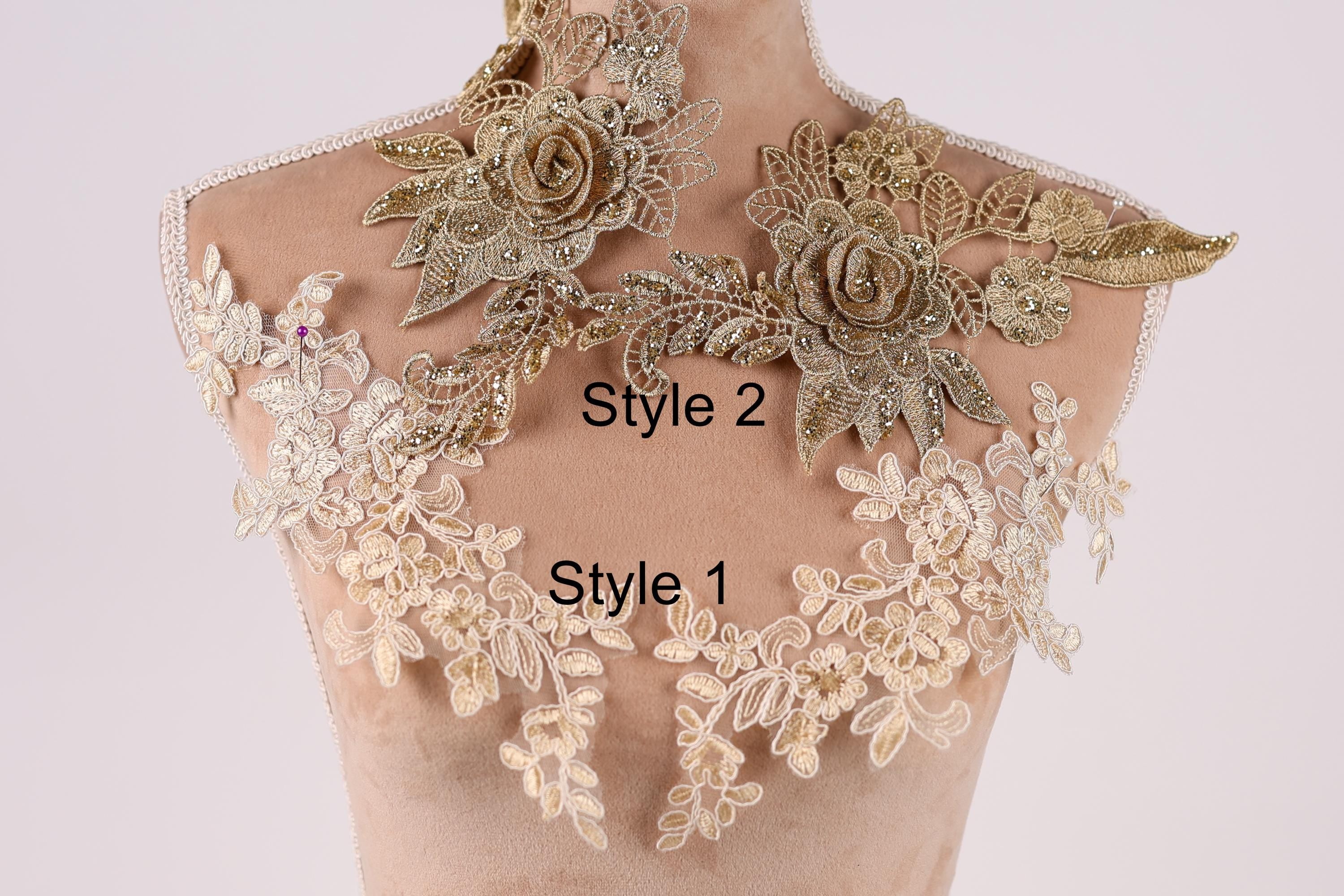 A mannequin with a decorative collar featuring intricate gold and white floral patterns.