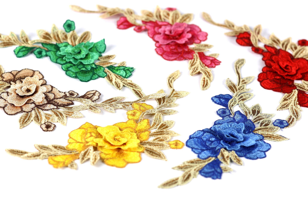 a variety of colorful floral embroidery pieces, including red, pink, yellow, blue, and brown flowers with green leaves.