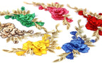 a variety of colorful floral embroidery pieces, including red, pink, yellow, blue, and brown flowers with green leaves.