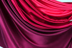 a close-up view of a fabric with a gradient of red and purple colors, creating a visually striking and vibrant appearance.