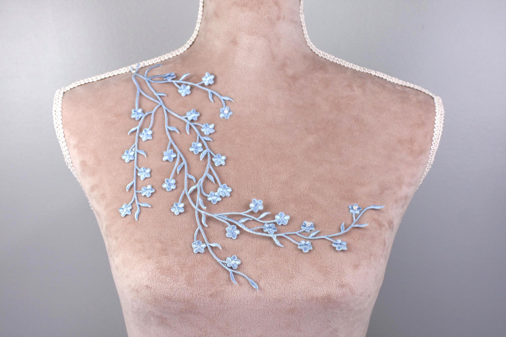 a mannequin with blue flowers on it's back