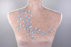 a mannequin with blue flowers on it's back