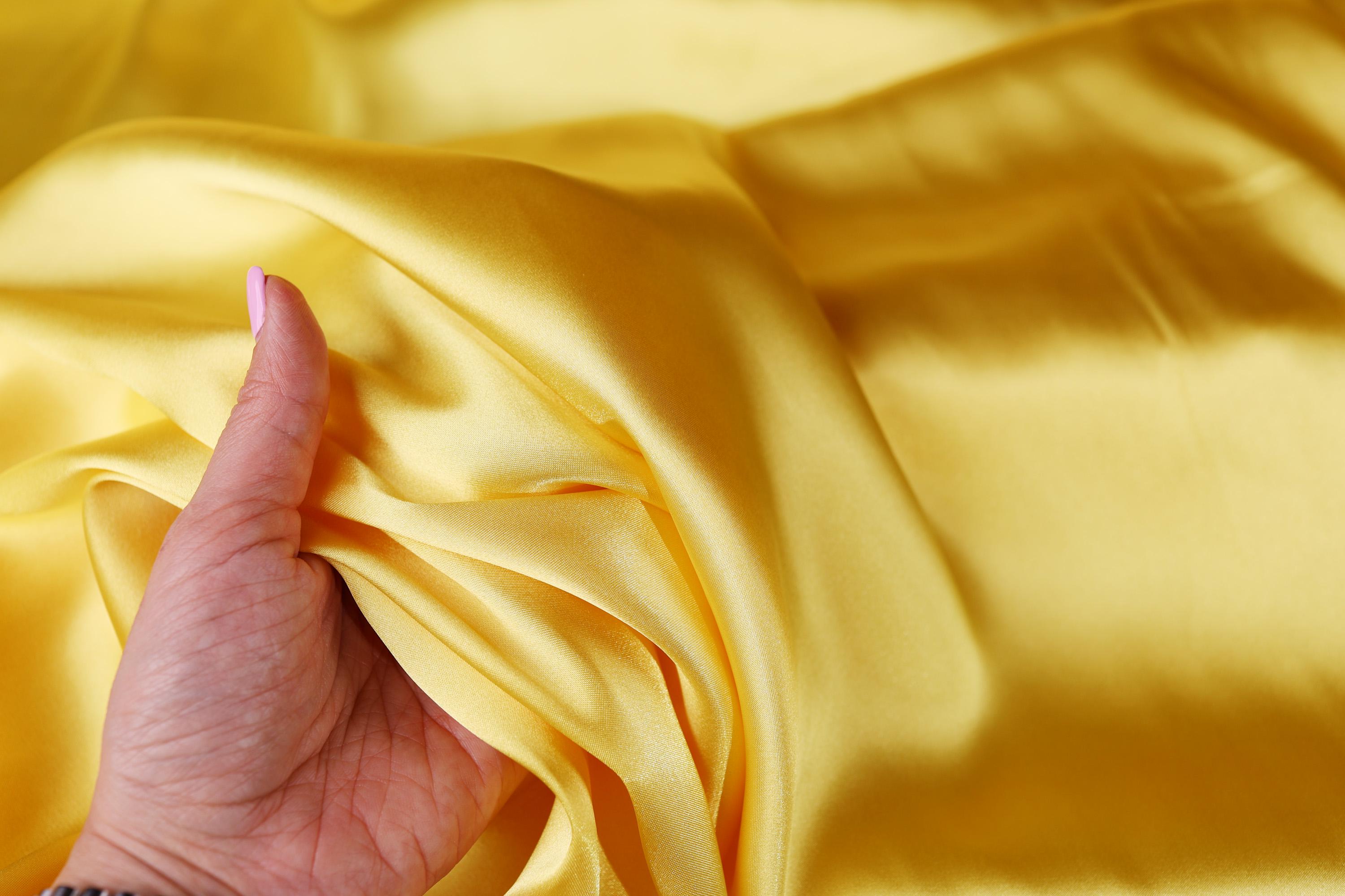 a person&#39;s hand on a yellow cloth