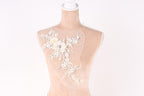 A mannequin with a decorative floral embroidery on its bust.