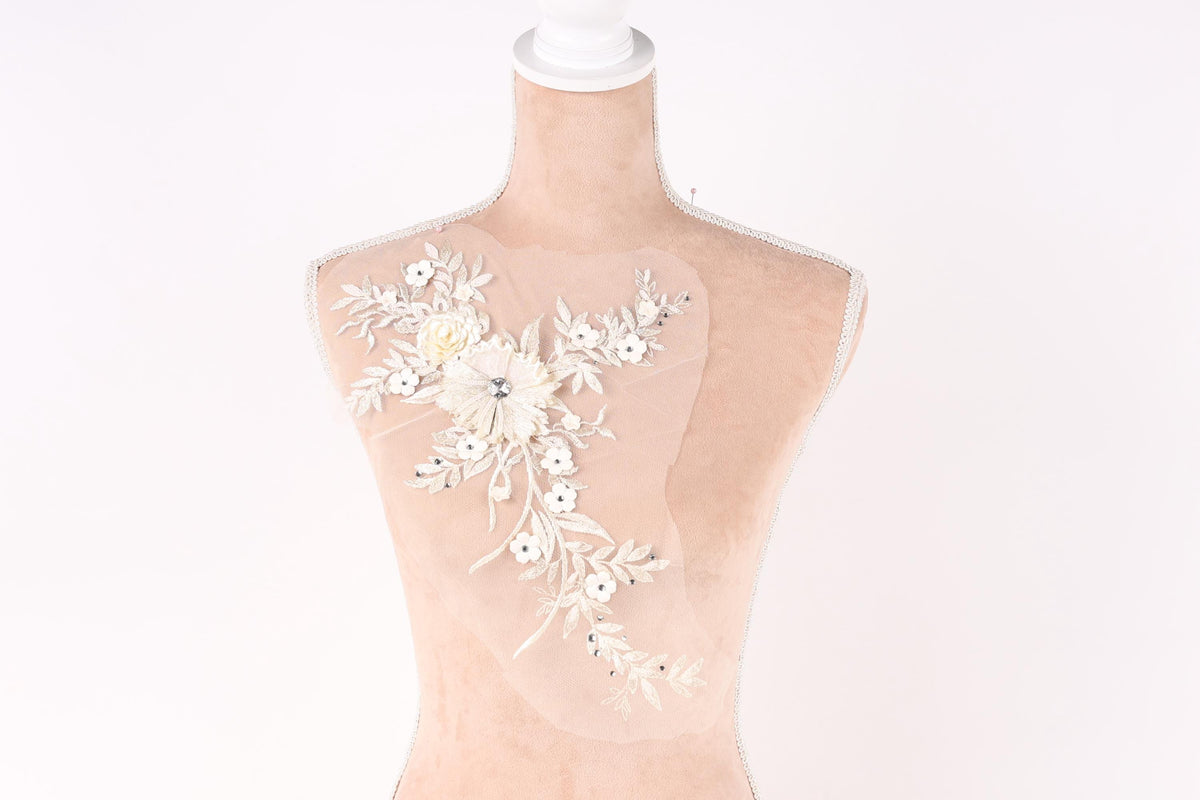 A mannequin with a decorative floral embroidery on its bust.
