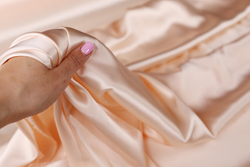 a woman&#39;s hand with a pink manicure on it