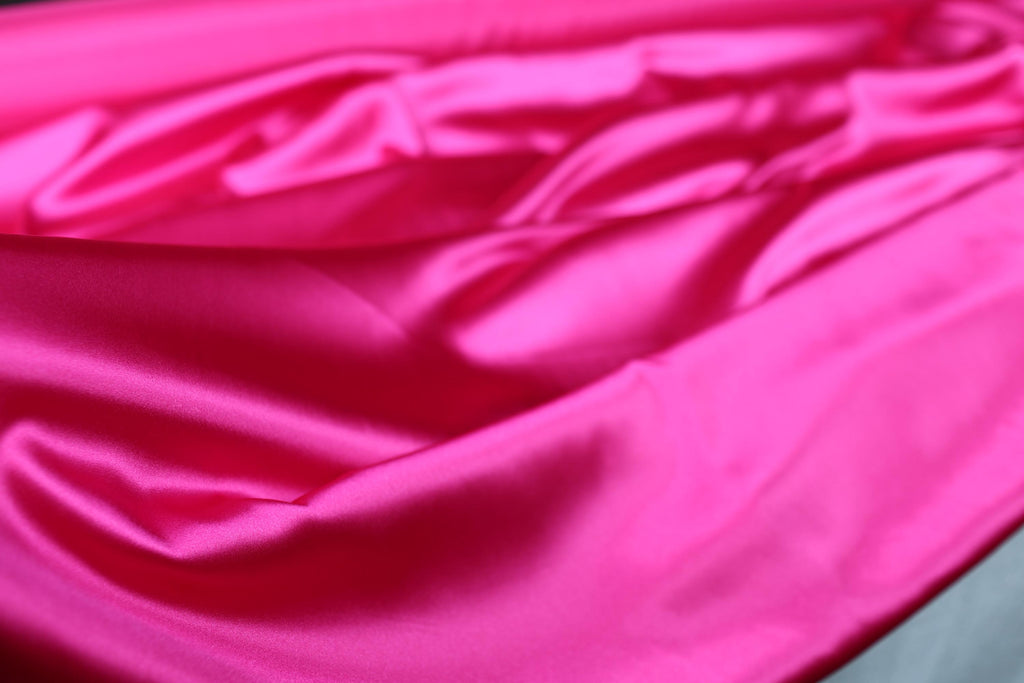a close up of a pink satin material
