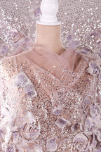 a mannequin wearing a dress with a pink and white floral pattern, as well as sequins and lace details.