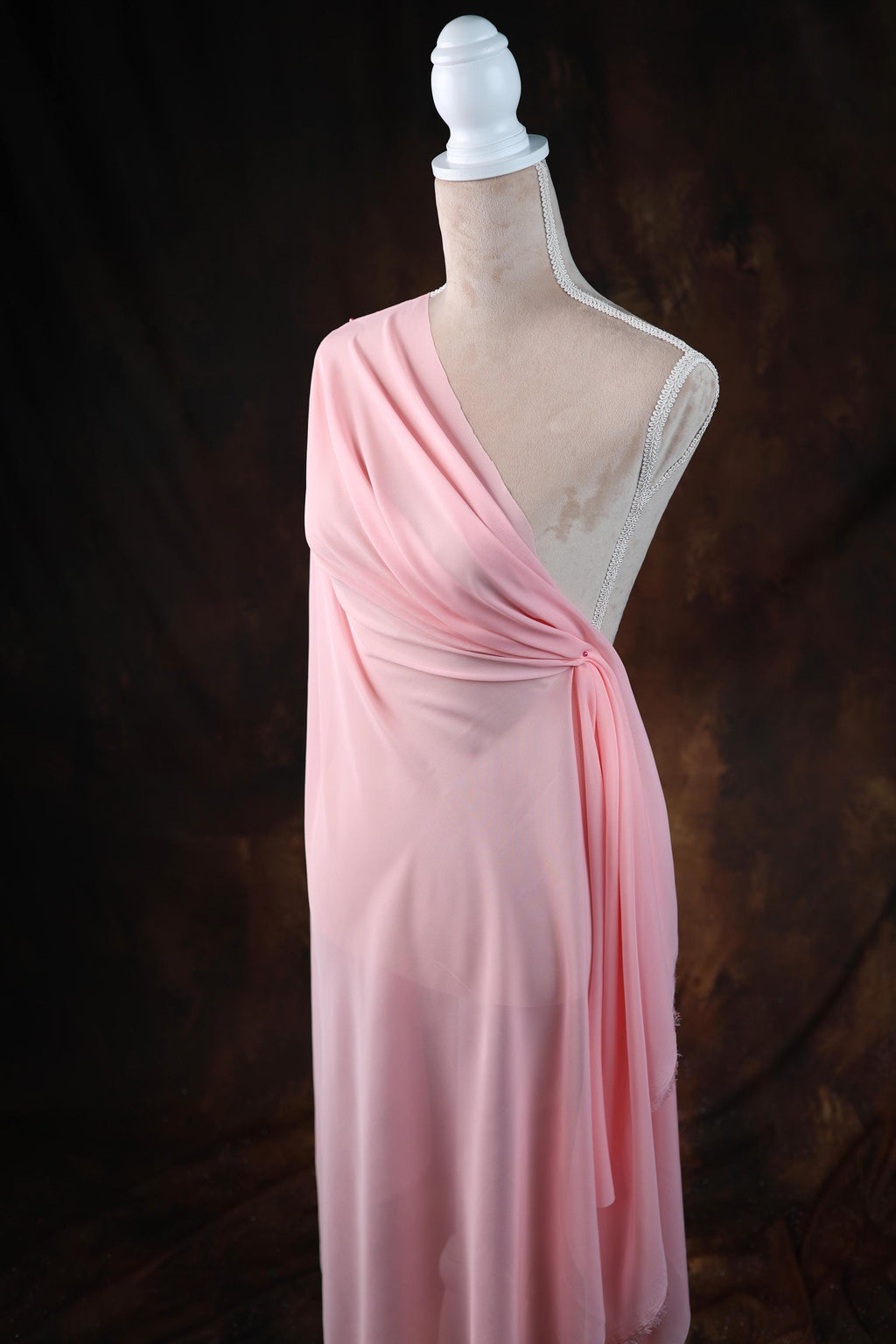 a dress on a mannequin on a black background