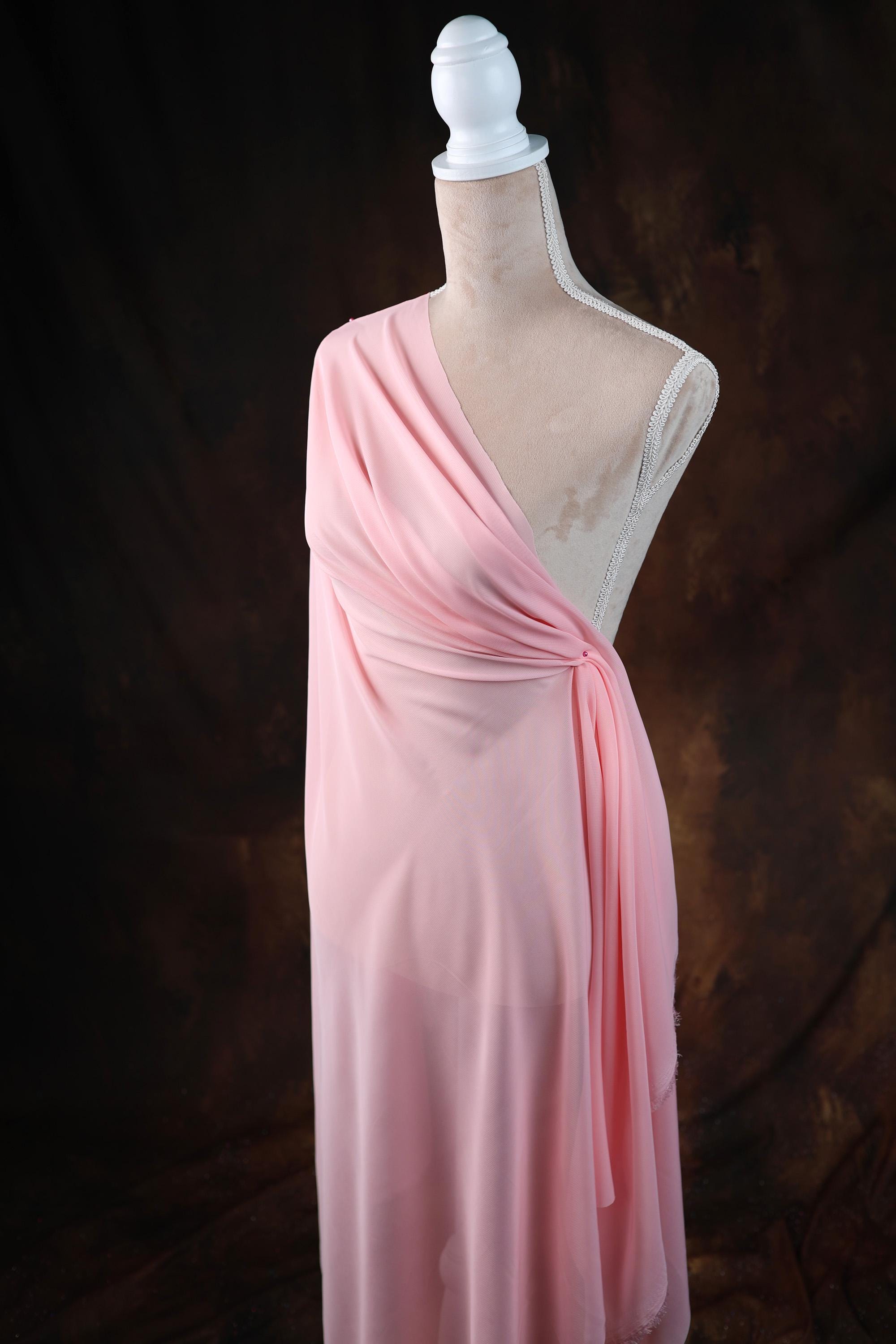 a dress on a mannequin on a black background