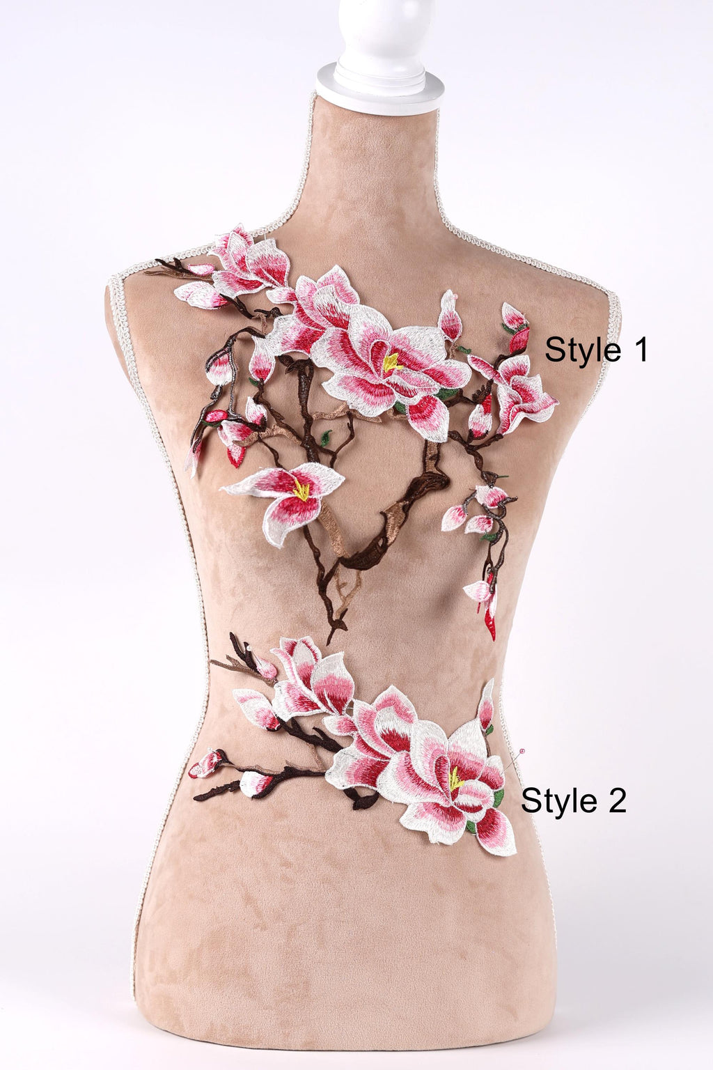 A mannequin with a beige body and pink and white floral embroidery on its torso.