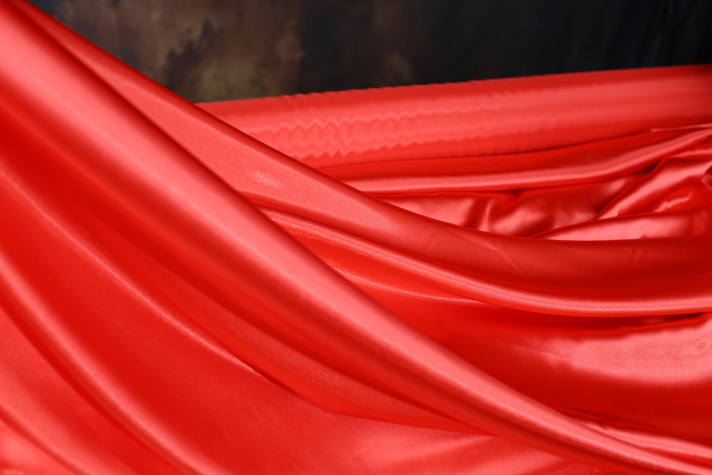 a red cloth is draped in the wind