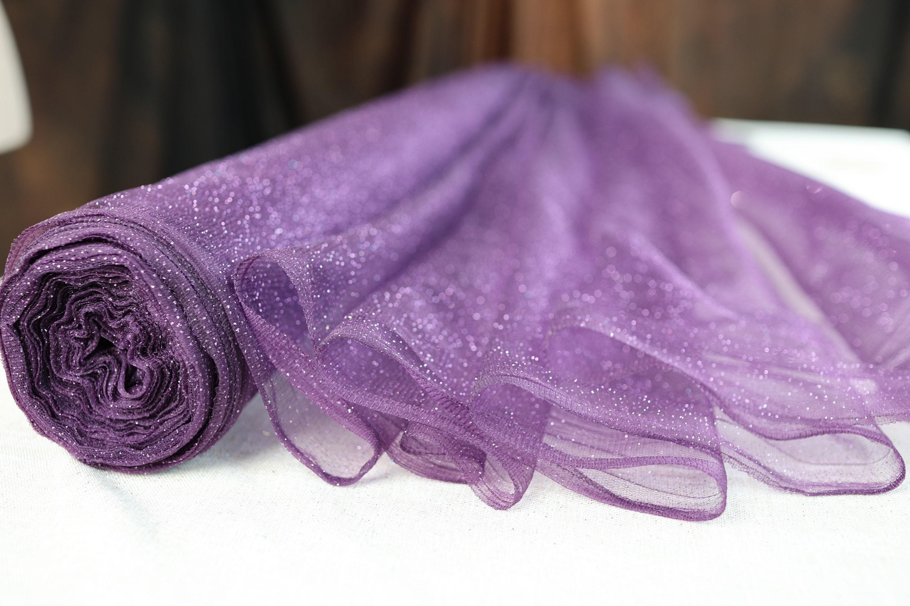 a roll of purple tulle sitting on top of a table