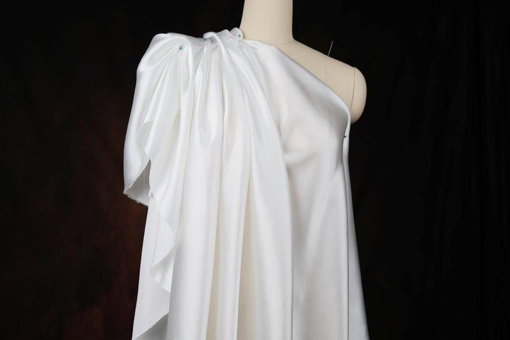 a white dress on a mannequin on a black background