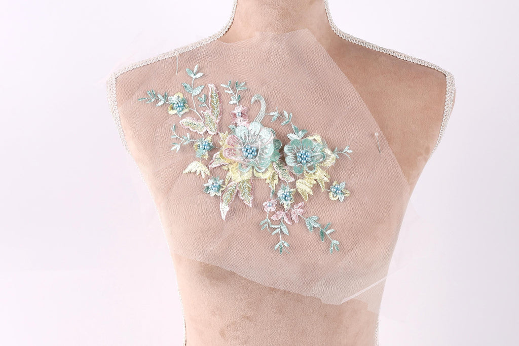 A mannequin with a delicate floral embroidered on its bust.