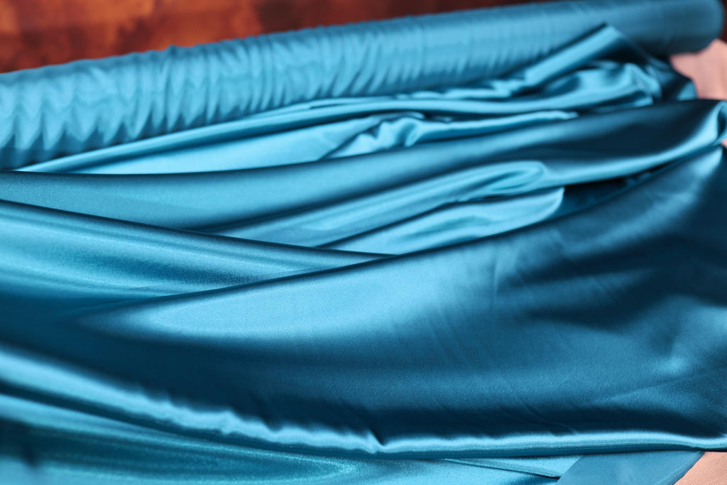 a close up of a blue satin material