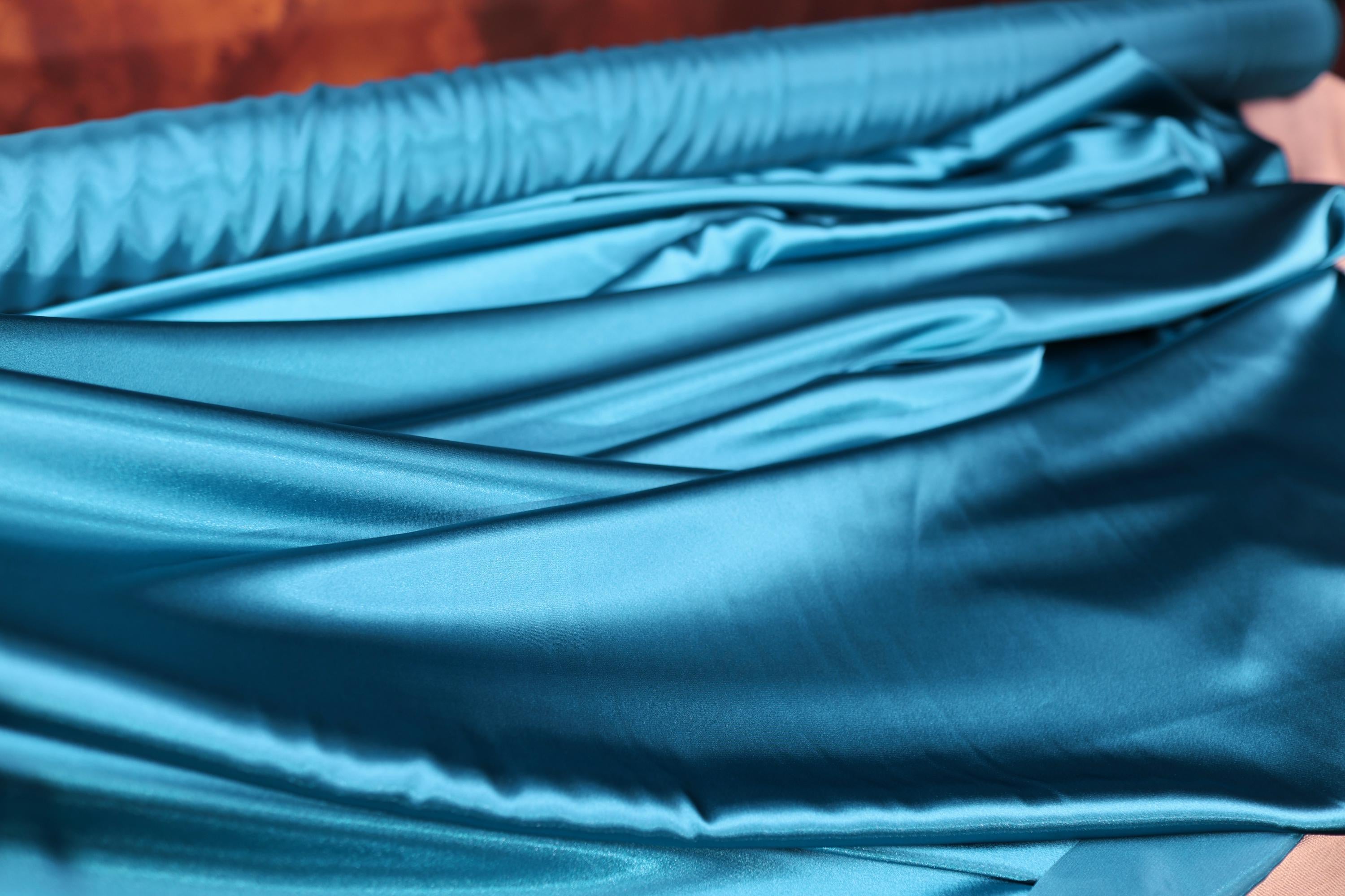 a close up of a blue satin material