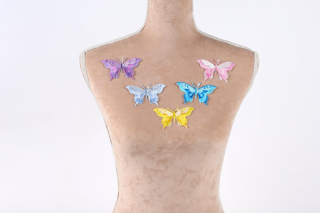 a mannequin with six colorful butterfly patches on its back.