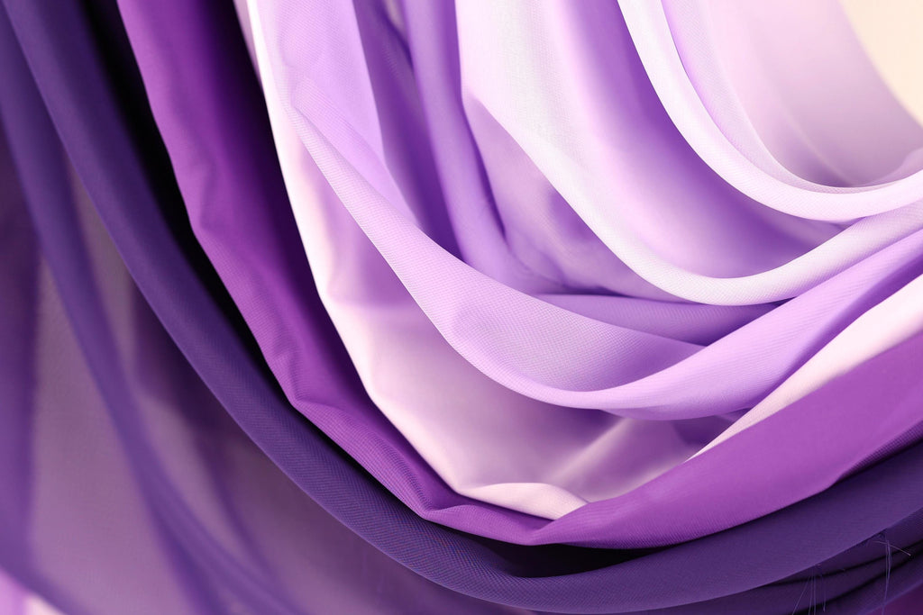 a close-up view of a collection of purple and white fabric, with the colors and textures creating a visually striking and vibrant composition.