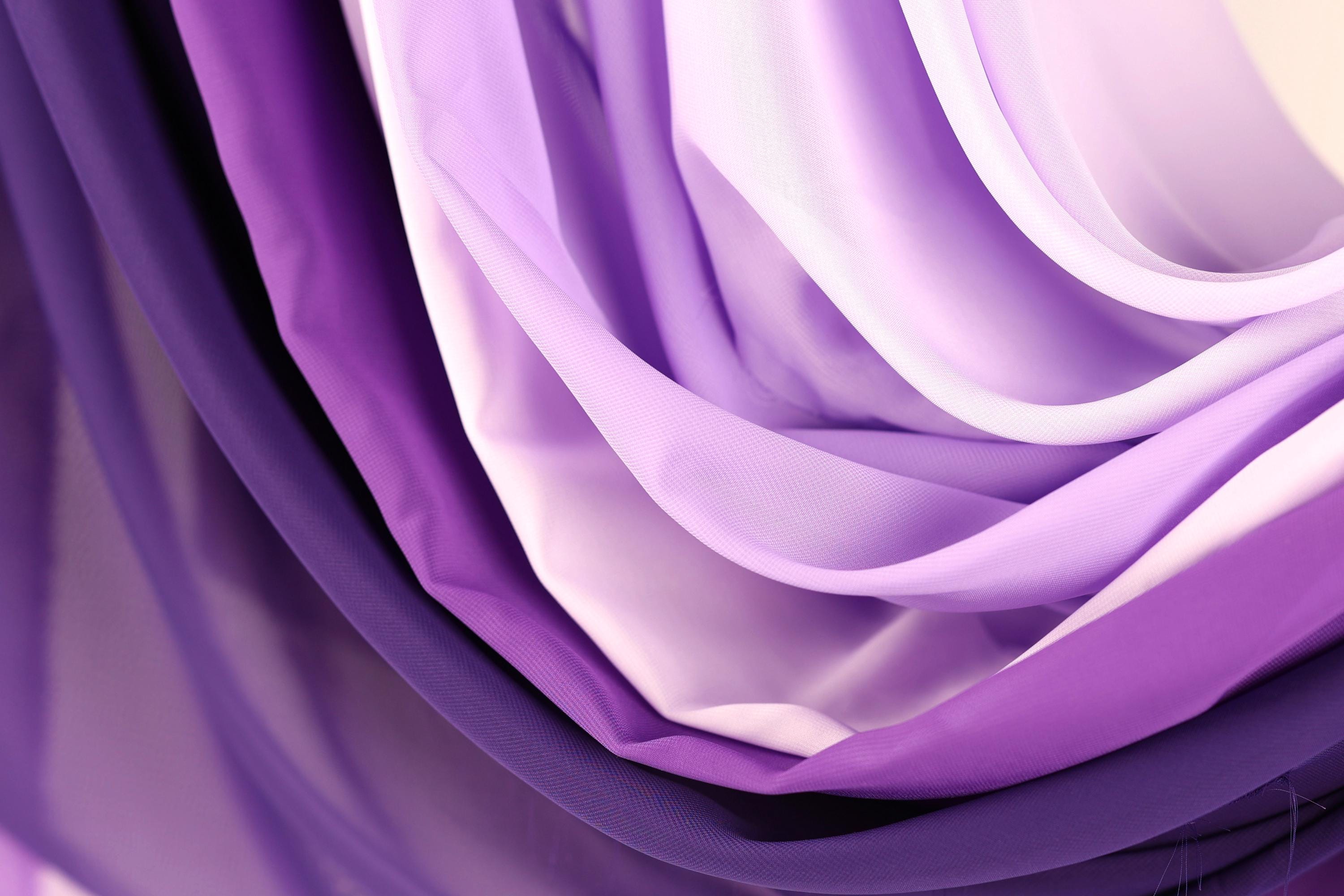 a close-up view of a collection of purple and white fabric, with the colors and textures creating a visually striking and vibrant composition.