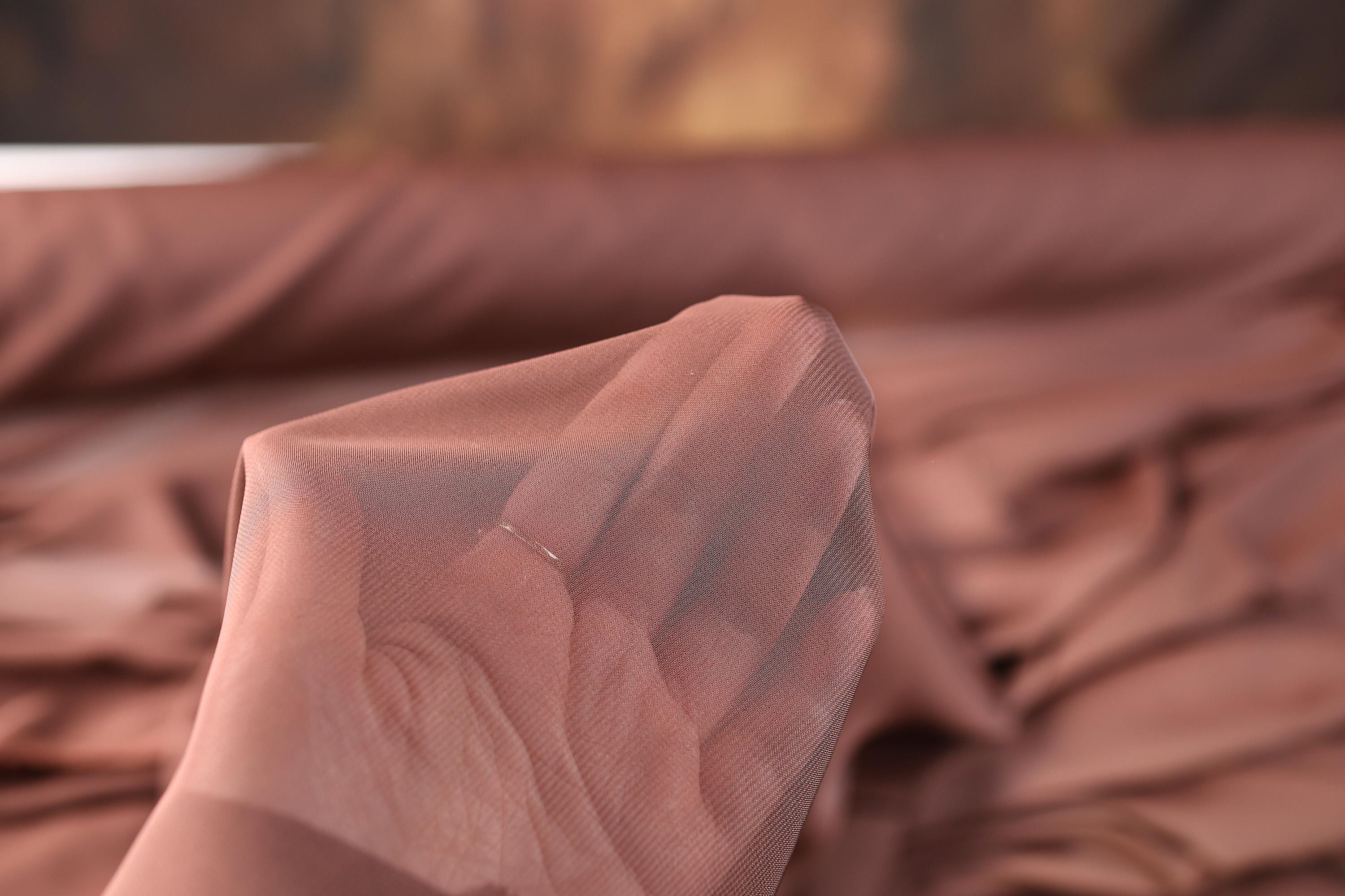 a close up of a piece of cloth on a bed