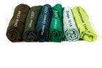 a collection of six rolled-up shirts in various colors, including olive green, hunter green, green, sage, and chartreuse.