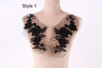 A mannequin with a black lace overlay on its chest area, featuring intricate floral designs.