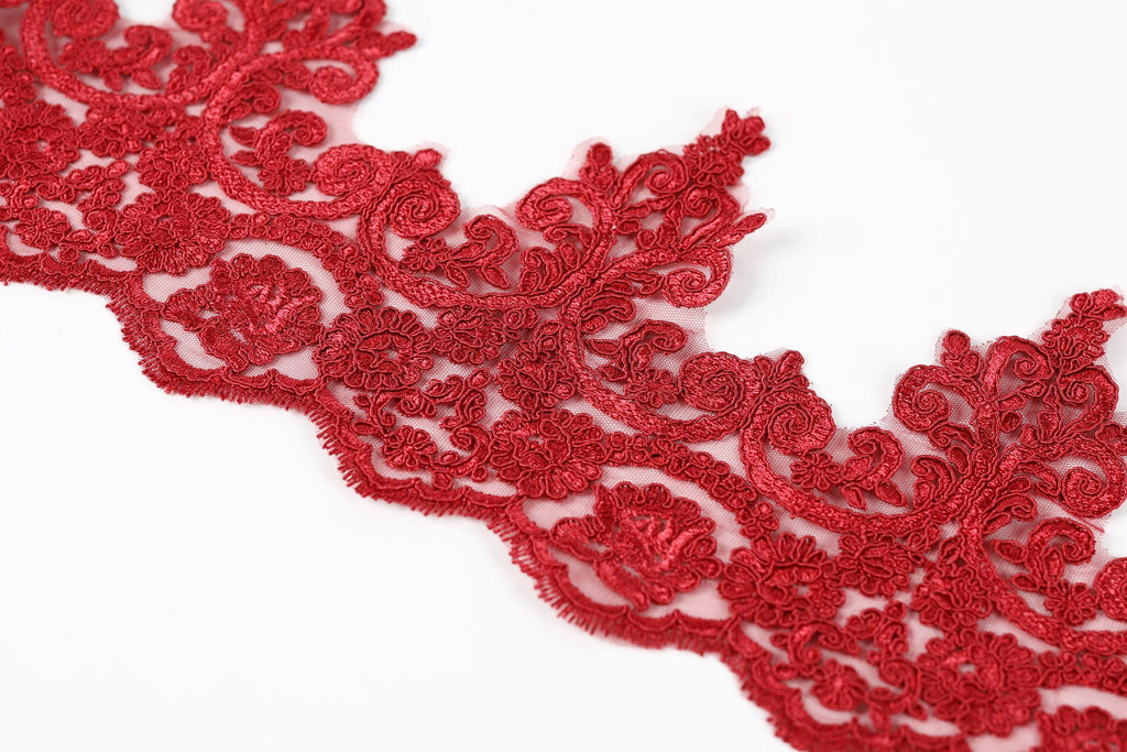a close-up view of a red, intricately designed lace or embroidery piece.
