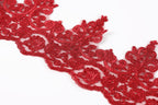 a close-up view of a red, intricately designed lace or embroidery piece.