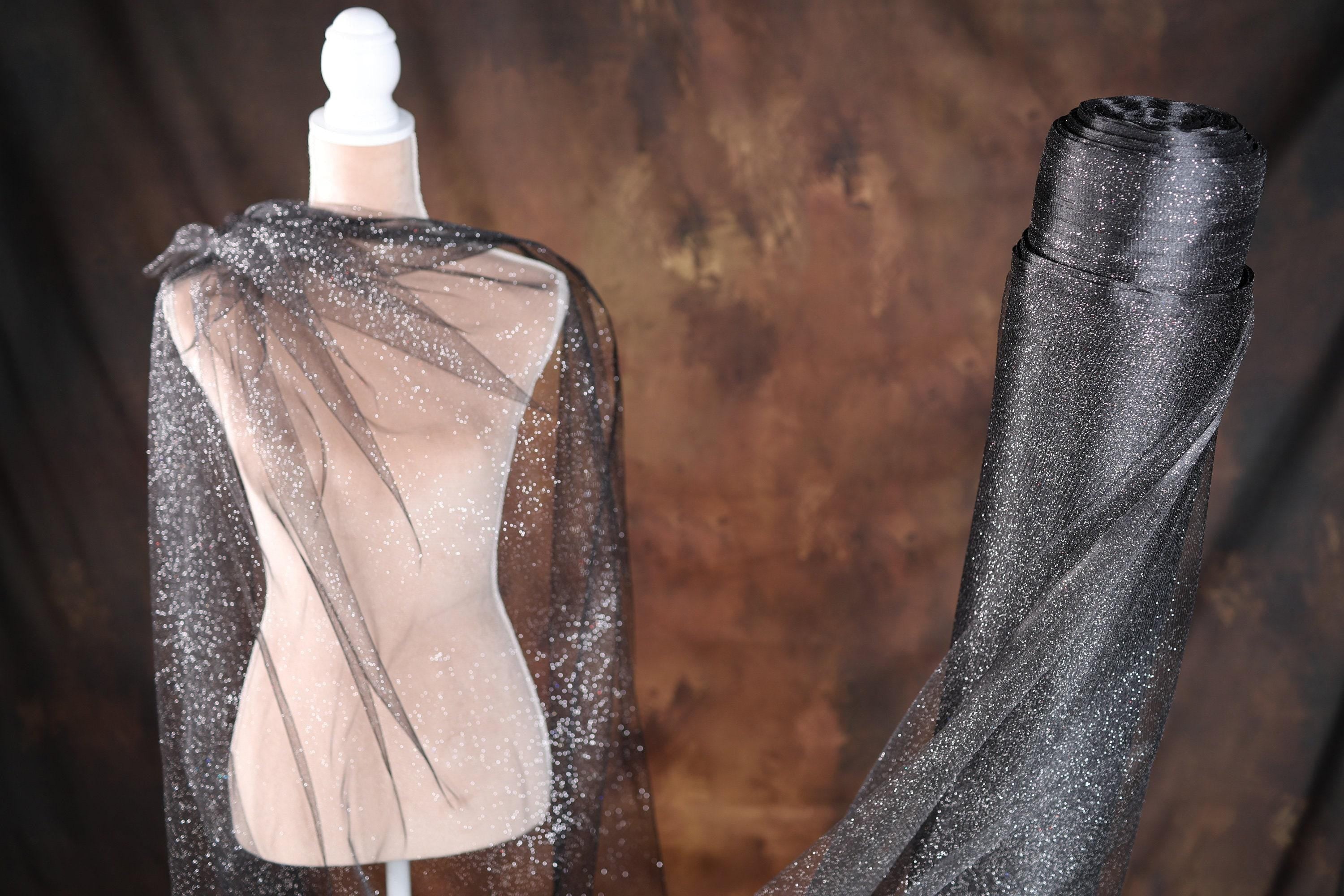 two mannequins are dressed in black and silver