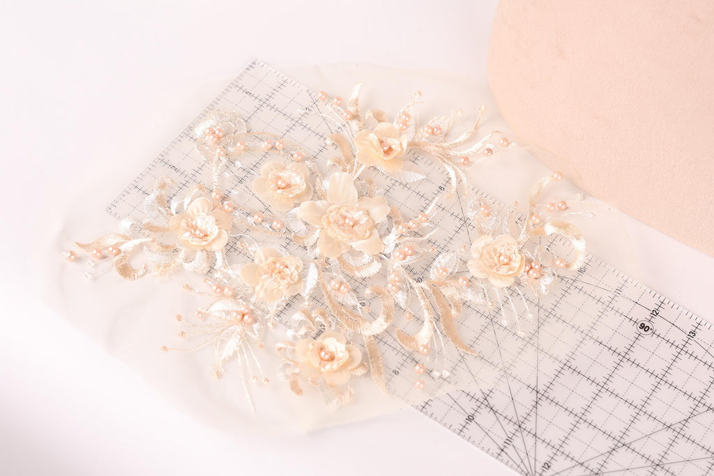 a delicate arrangement of white flowers with pink accents, placed on a transparent surface.