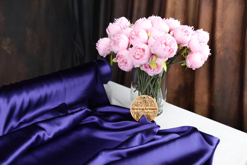 a vase filled with pink flowers on top of a table