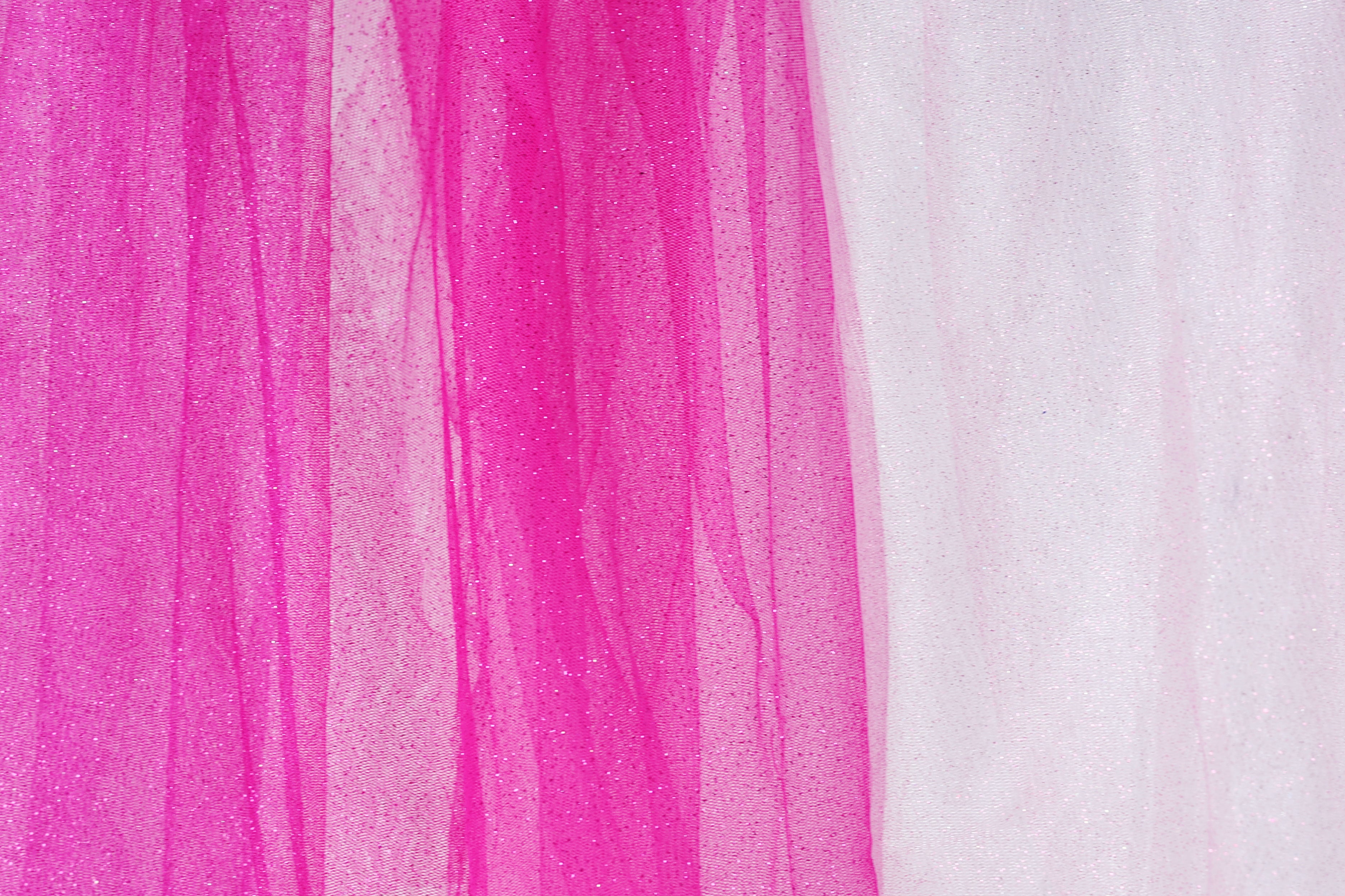 The image is a close-up of a fabric with a pink and white color scheme. The fabric appears to be a sheer material, with the pink fabric being more prominent and the white fabric partially visible on the right side.