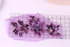 a clear ruler with a purple background, displaying a floral pattern with purple and pink flowers and leaves.