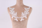 A mannequin with a white lace collar and floral embellishments on the bust area.