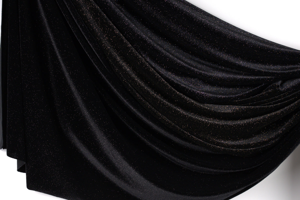 a black fabric with a shiny, glittery texture.