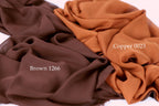 three different fabric swatches, each with a distinct color: brown, copper, and brown. The text "Brown 1266" is visible on the brown fabric, while "Copper 0023" is on the copper fabric.